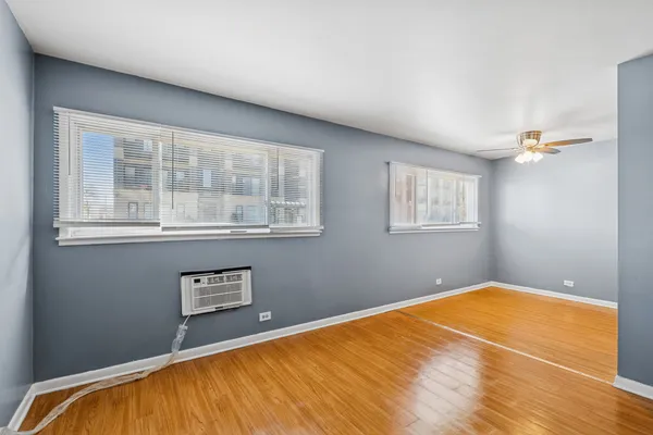 a view of a room with wooden floor and a window