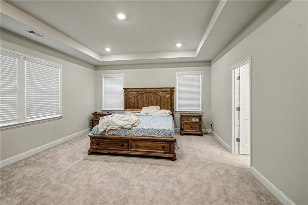 3068 Shirecrest Lane Dacula, GA 30019 - Photo 19 of 41 a spacious bedroom with a bed and a cabinets