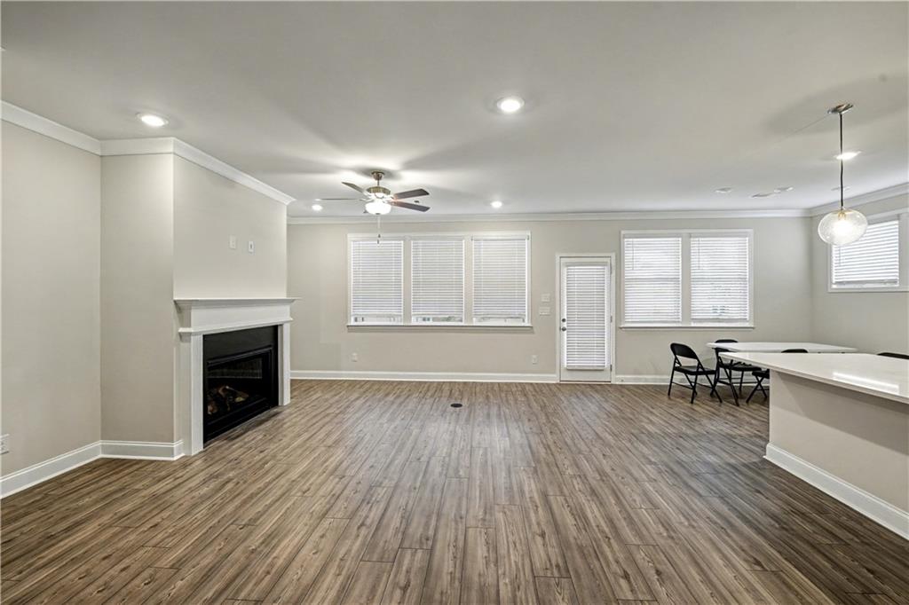 3068 Shirecrest Lane Dacula, GA 30019 - Photo 3 of 41 an empty room with wooden floor and fireplace