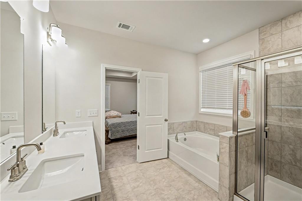 3068 Shirecrest Lane Dacula, GA 30019 - Photo 32 of 41 a bathroom with a tub sink and mirror