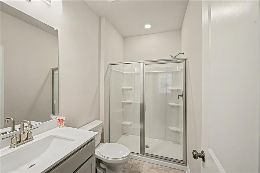 3068 Shirecrest Lane Dacula, GA 30019 - Photo 33 of 41 a bathroom with a sink a toilet and shower