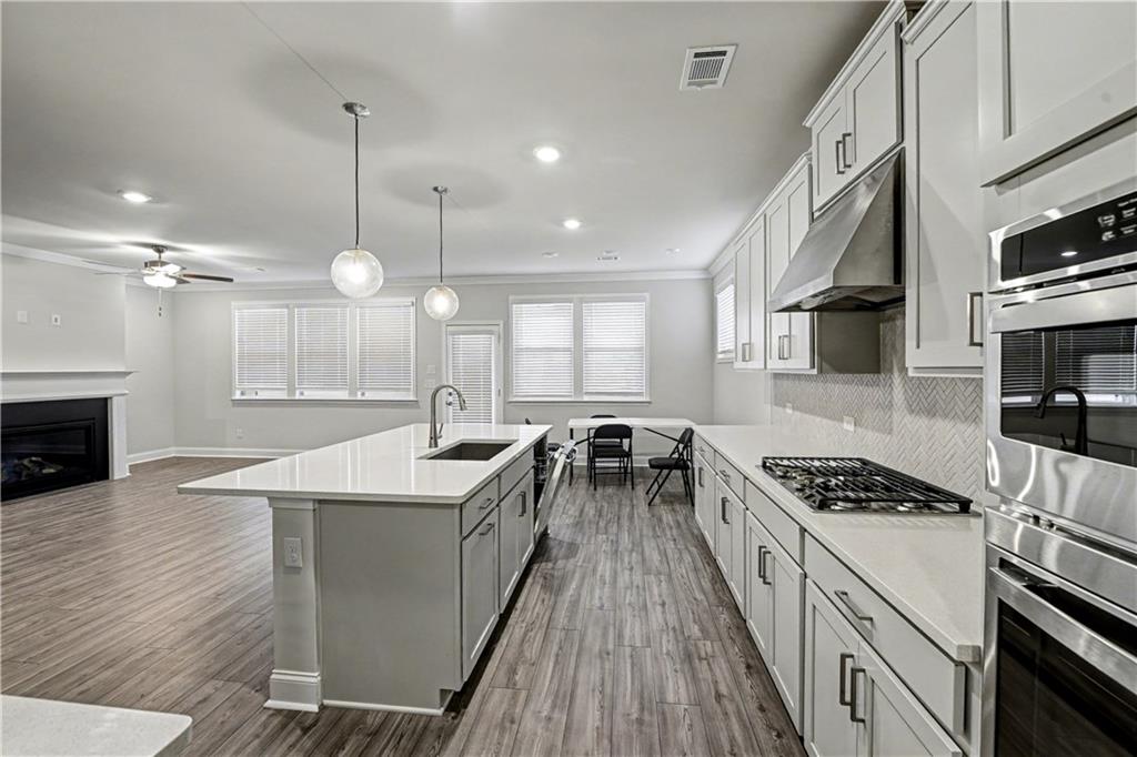 3068 Shirecrest Lane Dacula, GA 30019 - Photo 6 of 41 a kitchen with stainless steel appliances granite countertop a sink stove and cabinets