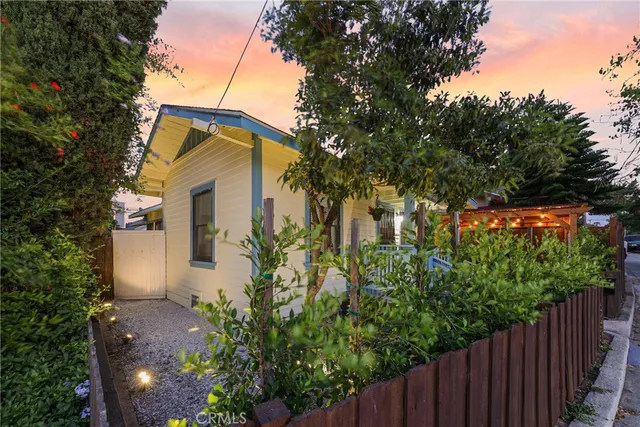 a yellow house with trees in front of it
