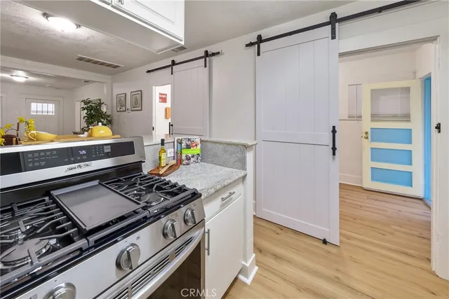a kitchen with a stove and a refrigerator