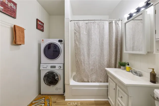 a utility room with a sink a washer and dryer next to a window