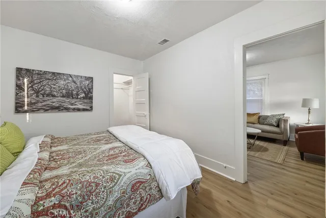 a bedroom with a bed and a painting on the wall