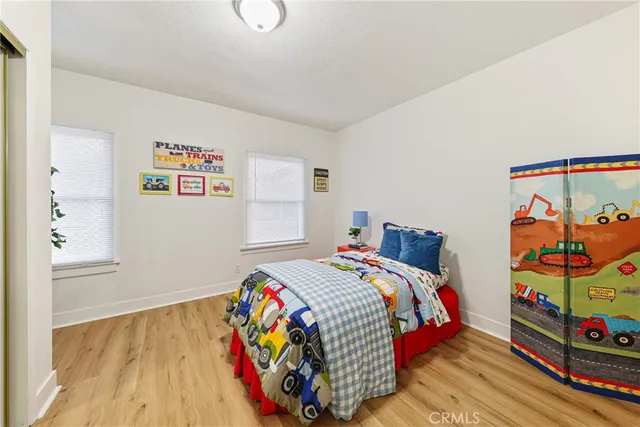 a bed sitting in a bedroom next to a window