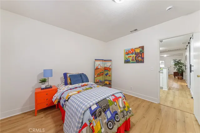 a bed room with a bed and a painting on the wall