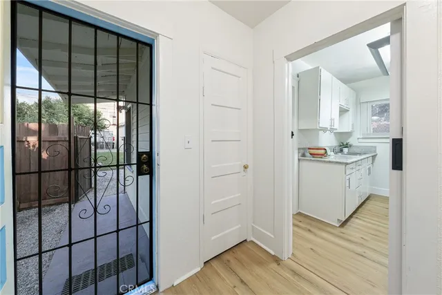 a kitchen with a refrigerator and white cabinets