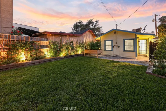 a front view of a house with a yard table and chairs