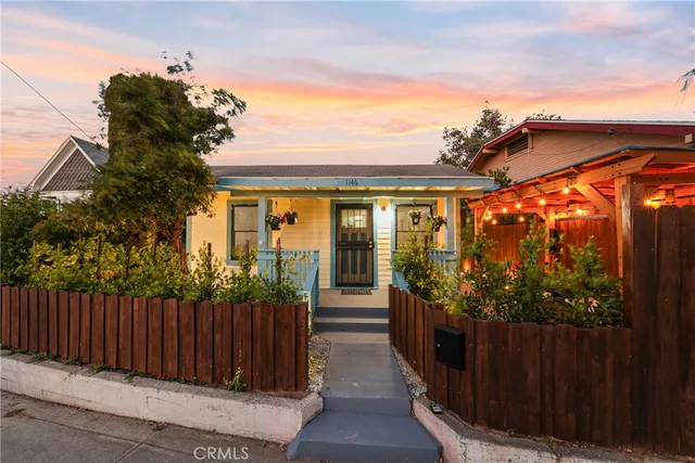 a view of a house with wooden fence