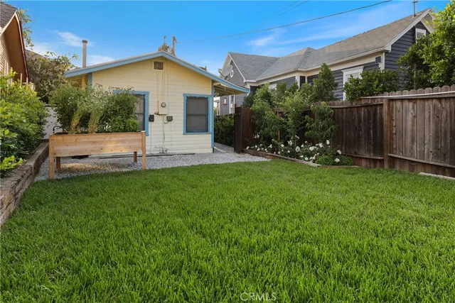 a front view of house with a garden