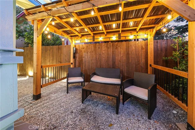 a backyard of a house with barbeque oven table and chairs