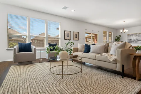 a living room with furniture and a lamp