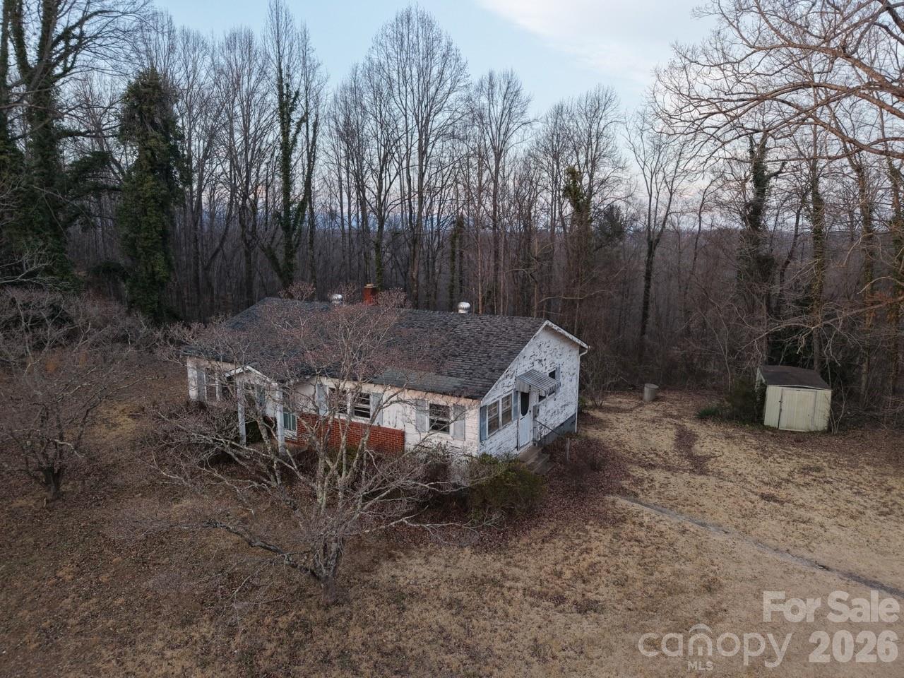a view of a chairs and table in the backyard