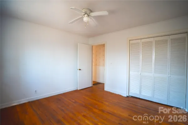a view of an empty room with a fan