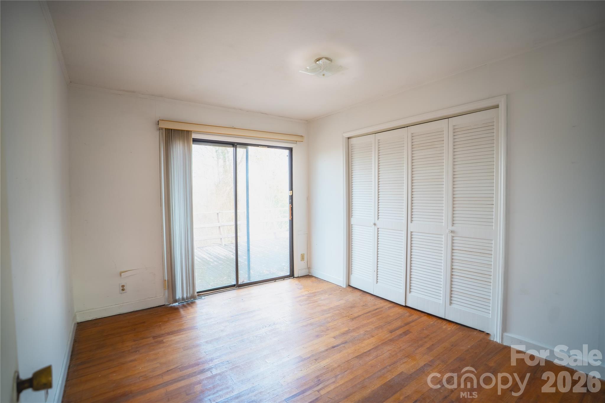 859 Stacy Hill Road Marion, NC 28752 - Photo 13 of 23 a view of an empty room with wooden floor and a window