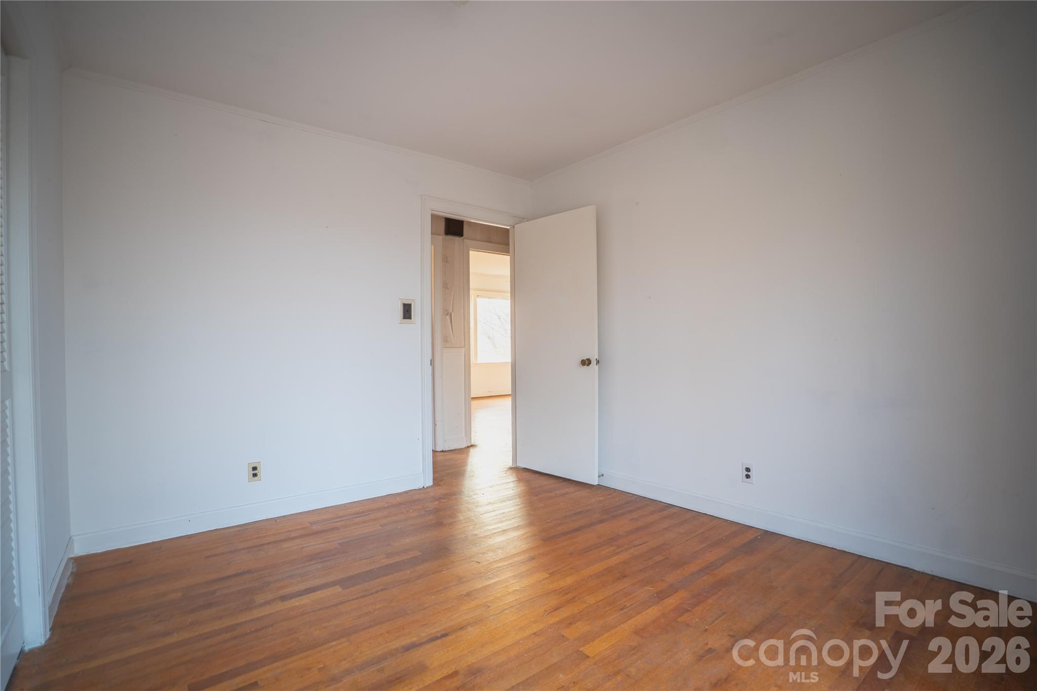859 Stacy Hill Road Marion, NC 28752 - Photo 14 of 23 a view of an empty room with wooden floor