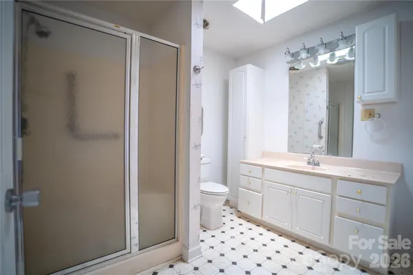 a spacious bathroom with a double vanity sink mirror and toilet
