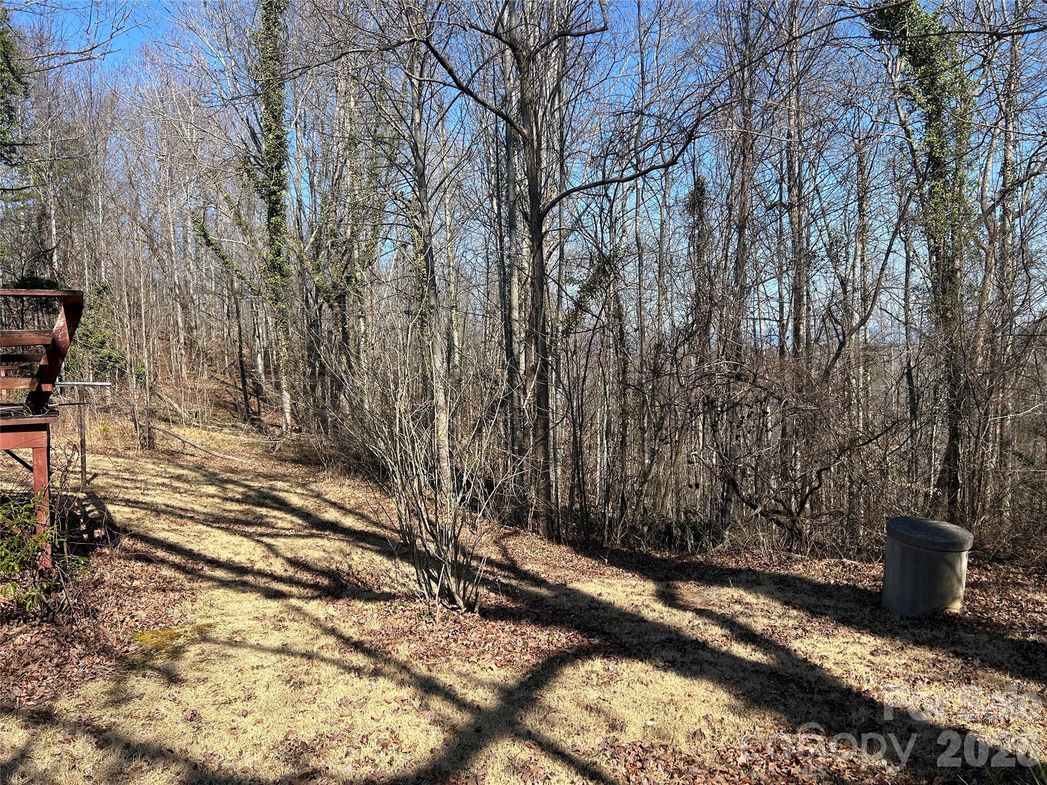 859 Stacy Hill Road Marion, NC 28752 - Photo 21 of 23 a view of a backyard with wooden fence and trees