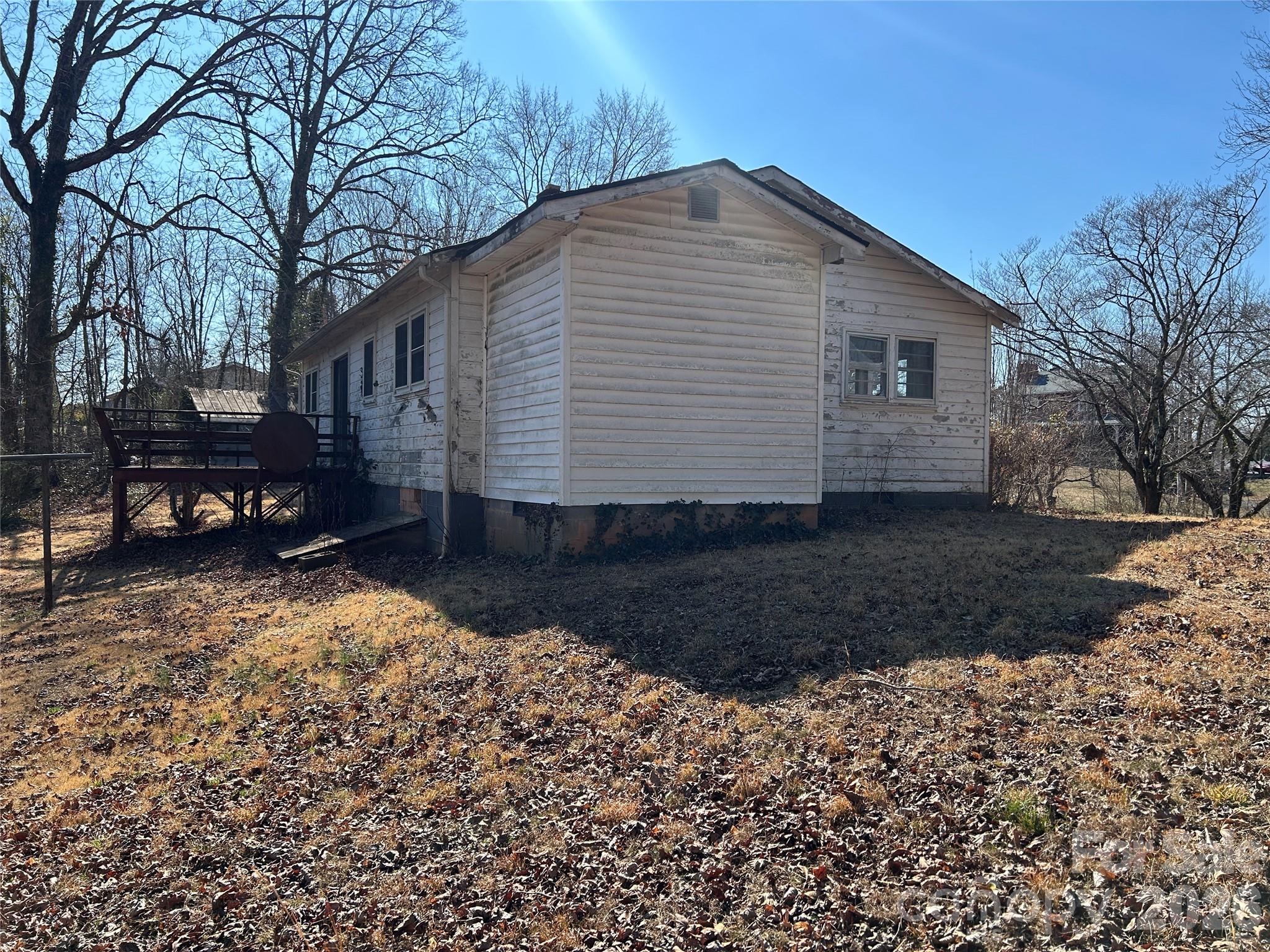859 Stacy Hill Road Marion, NC 28752 - Photo 4 of 23 a backyard of a house with wooden fence and large trees