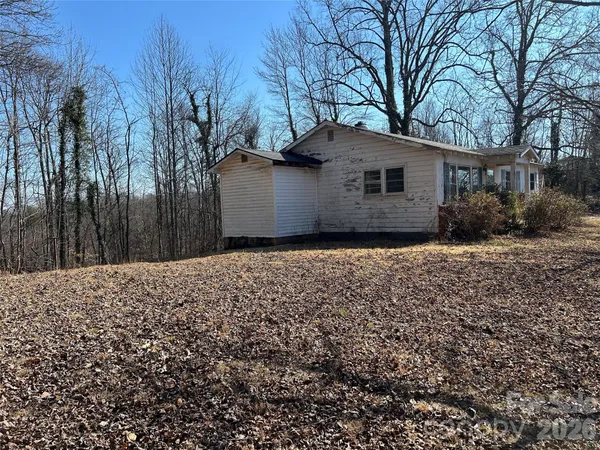 a house that has a tree in front of it