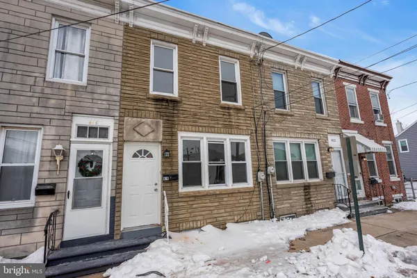 a view of a brick house with large windows