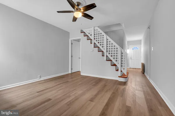 a view of empty room with wooden floor