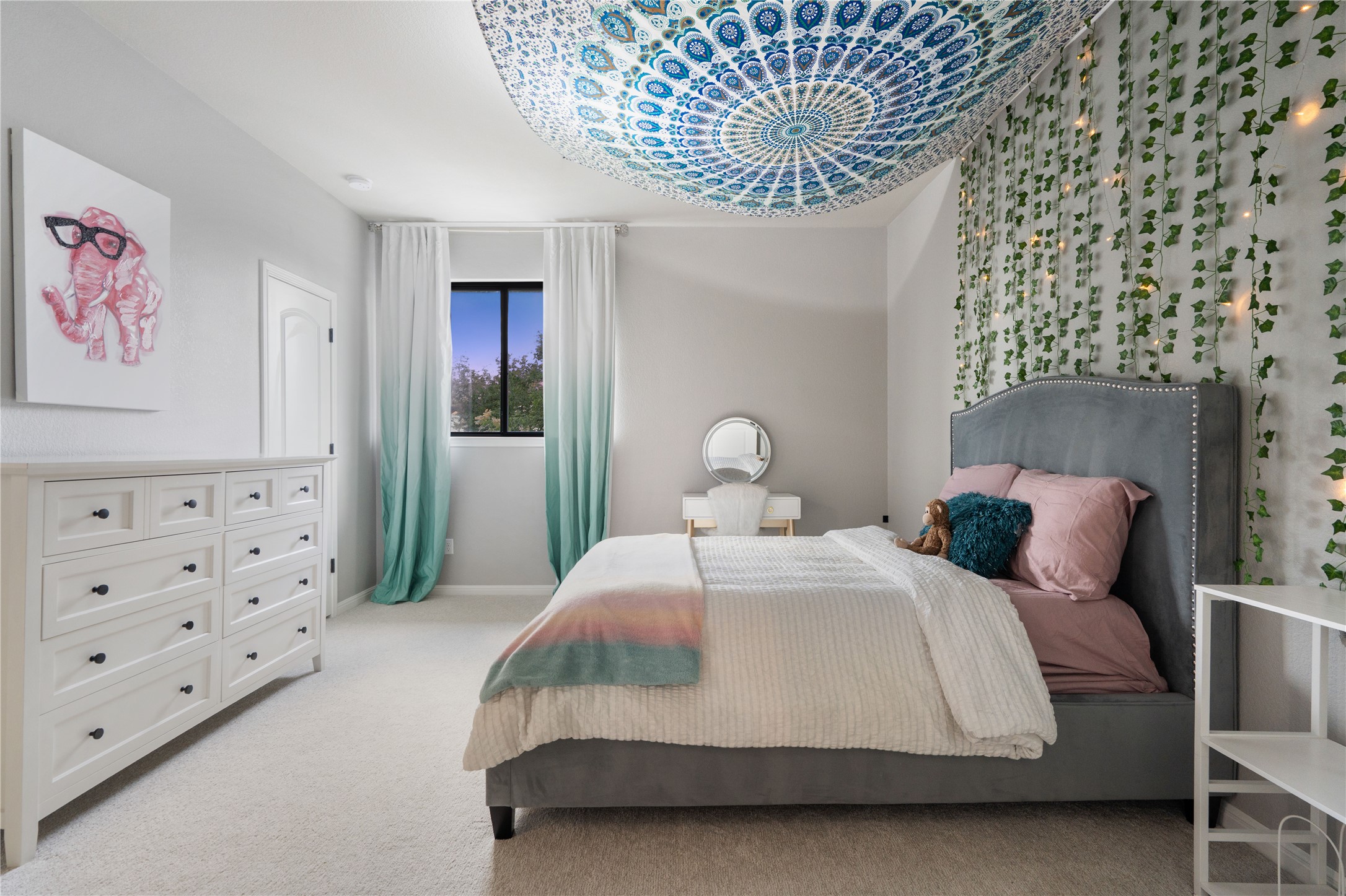 2829 Long Lasso Pass Leander, TX 78641 - Photo 25 of 40 a bedroom with a bed and a chandelier