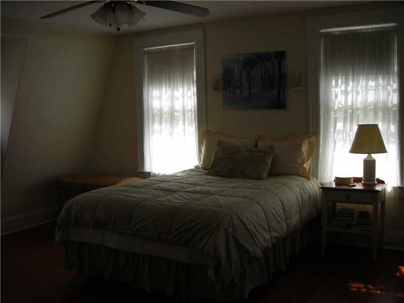 242 West Norwalk Road Norwalk, CT 06850 - Photo 12 of 13 a bedroom with a bed and a lamp on the dresser