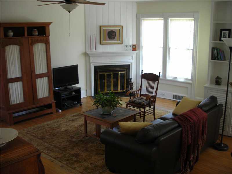 242 West Norwalk Road Norwalk, CT 06850 - Photo 7 of 13 a living room with furniture a flat screen tv and a fireplace