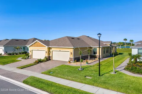 a view of a house with a backyard and a small yard