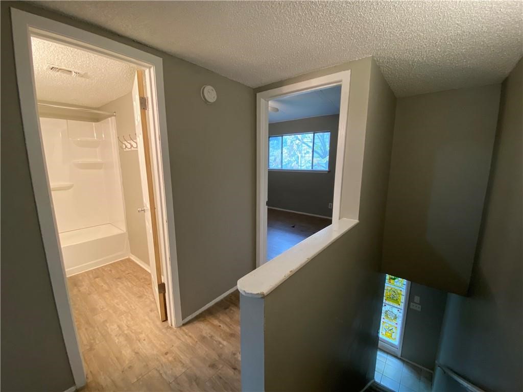 2413 Leon Street, Unit 101 Austin, TX 78705 - Photo 15 of 22 a view of hallway with stairs and wooden floor