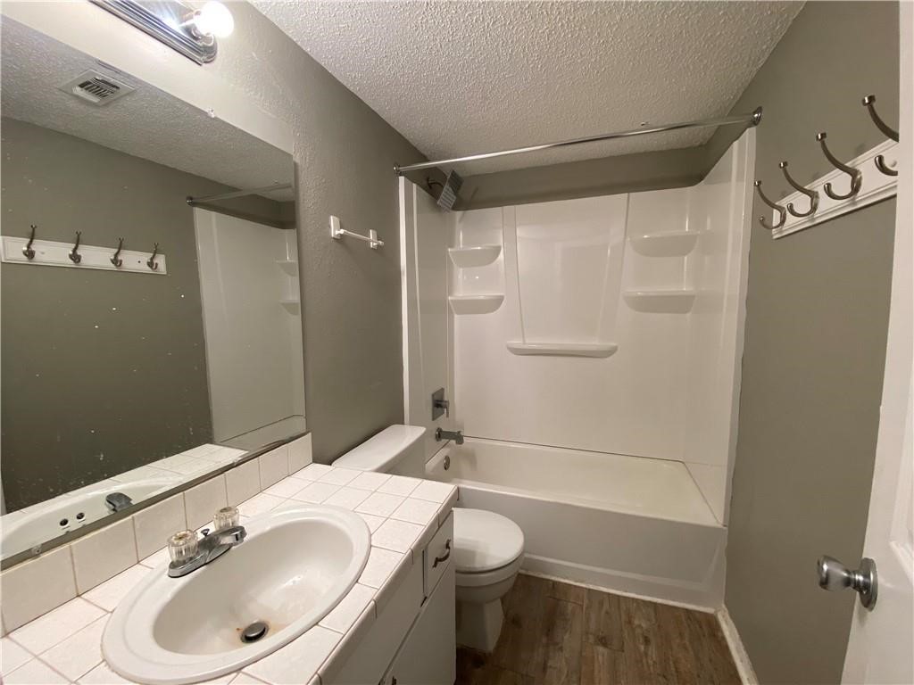 2413 Leon Street, Unit 101 Austin, TX 78705 - Photo 17 of 22 a bathroom with a sink toilet and shower