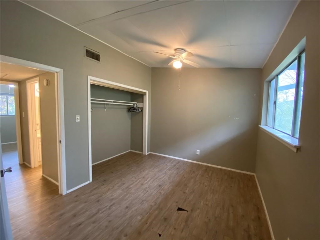 2413 Leon Street, Unit 101 Austin, TX 78705 - Photo 19 of 22 wooden floor in an empty room with a window