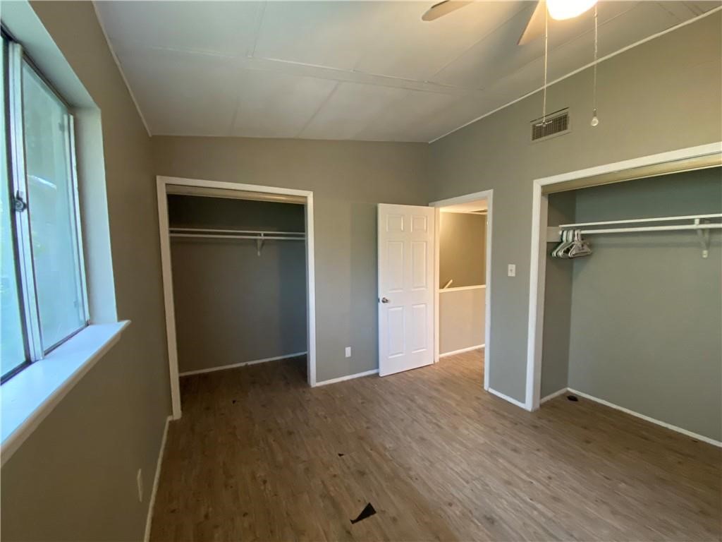 2413 Leon Street, Unit 101 Austin, TX 78705 - Photo 20 of 22 an empty room with wooden floor closet and windows