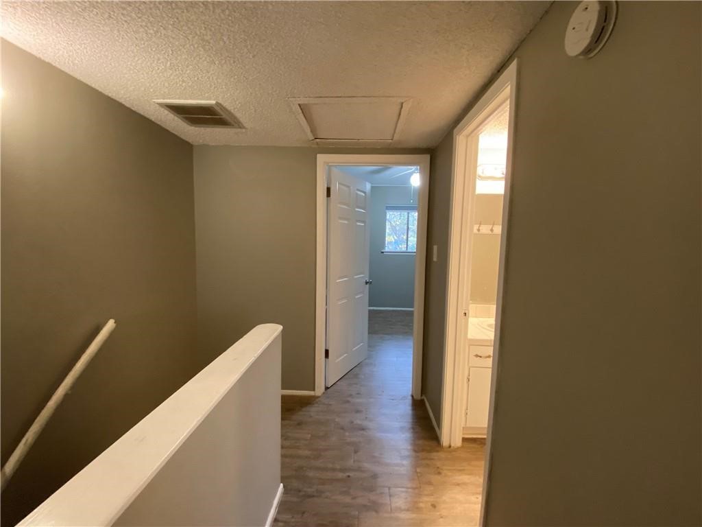 2413 Leon Street, Unit 101 Austin, TX 78705 - Photo 21 of 22 a view of a hallway with wooden floor