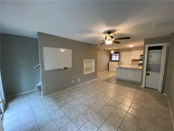 a kitchen with a sink a refrigerator and cabinets