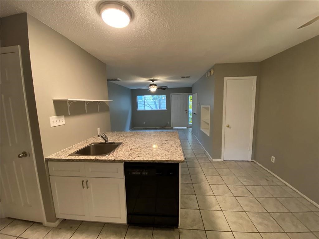 2413 Leon Street, Unit 101 Austin, TX 78705 - Photo 9 of 22 a bathroom with a granite countertop sink a toilet and a mirror