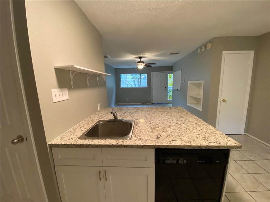 2413 Leon Street, Unit 101 Austin, TX 78705 - Photo 10 of 22 a bathroom with a granite countertop sink and a mirror