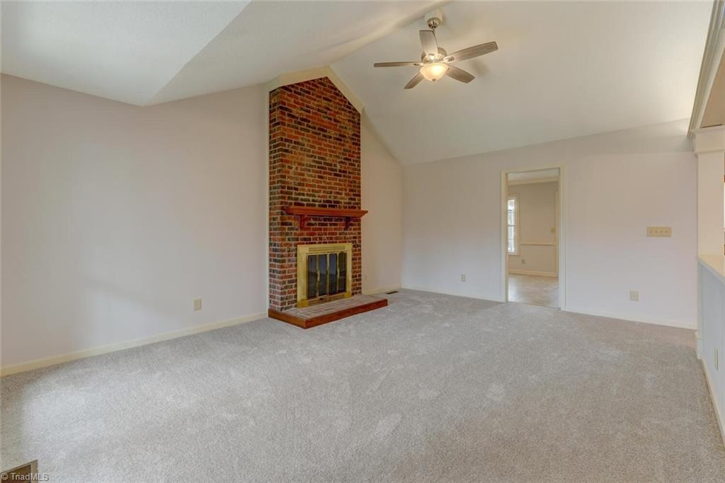 Vaulted ceilings in the main family space make for a dramatic entry. The fireplace adds to the coziness of this home.