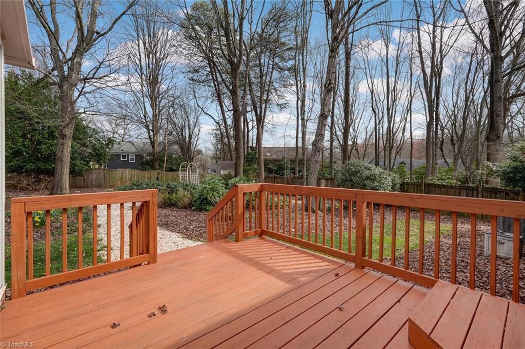 5204 Nantucket Road Greensboro, NC 27455 - Photo 36 of 41 Sunroom spills out on to the deck. A great place to grill as well as entertain.