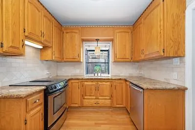 a kitchen with stainless steel appliances granite countertop a sink stove and cabinets