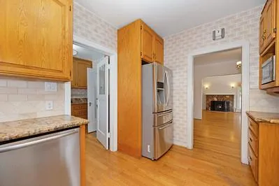 a view of a kitchen cabinets and a refrigerator
