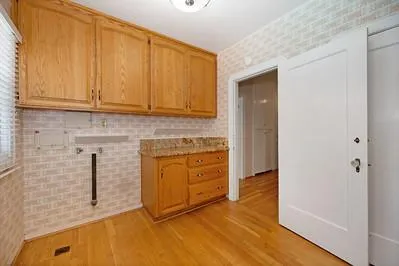a view of an empty room with a kitchen