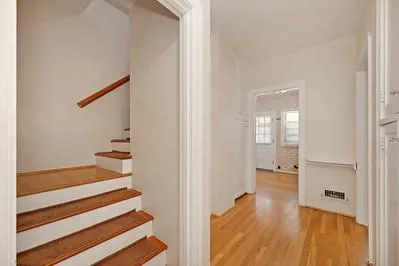 a view of entryway with wooden floor and stairs