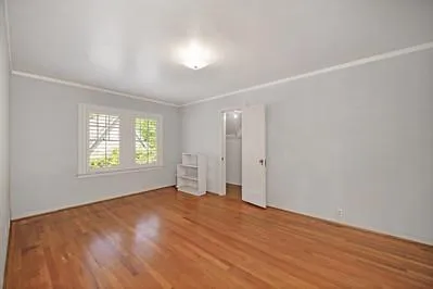 wooden floor in an empty room with a window
