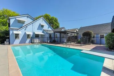 a view of a house with swimming pool and porch