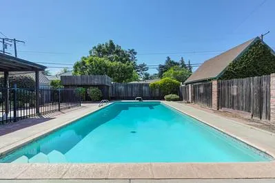 a view of backyard with seating and green space
