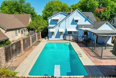 a view of a house with pool yard and deck